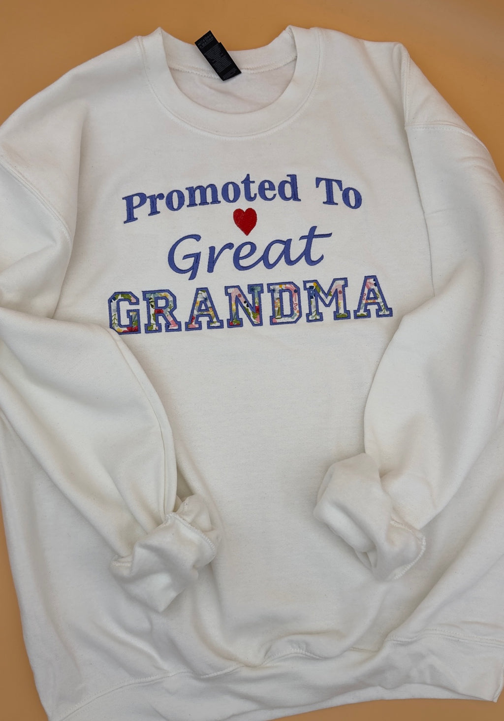 White crewneck sweatshirt with Promoted to Great Grandma appliqué lettering