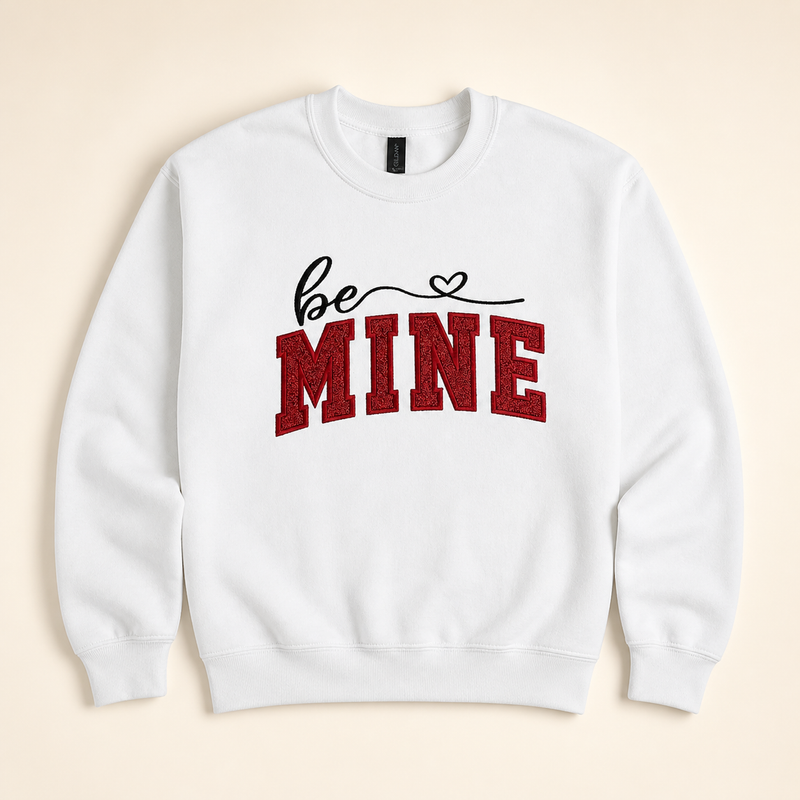 White Be Mine embroidered sweatshirt on a warm ivory studio background