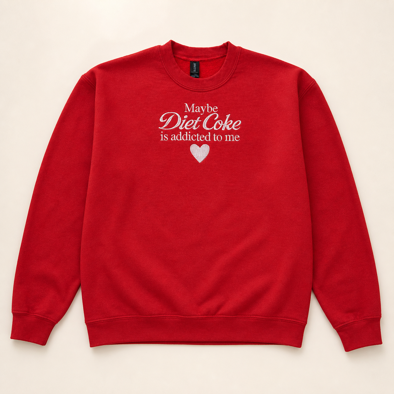Red Diet Coke date embroidered sweatshirt on a warm ivory studio background
