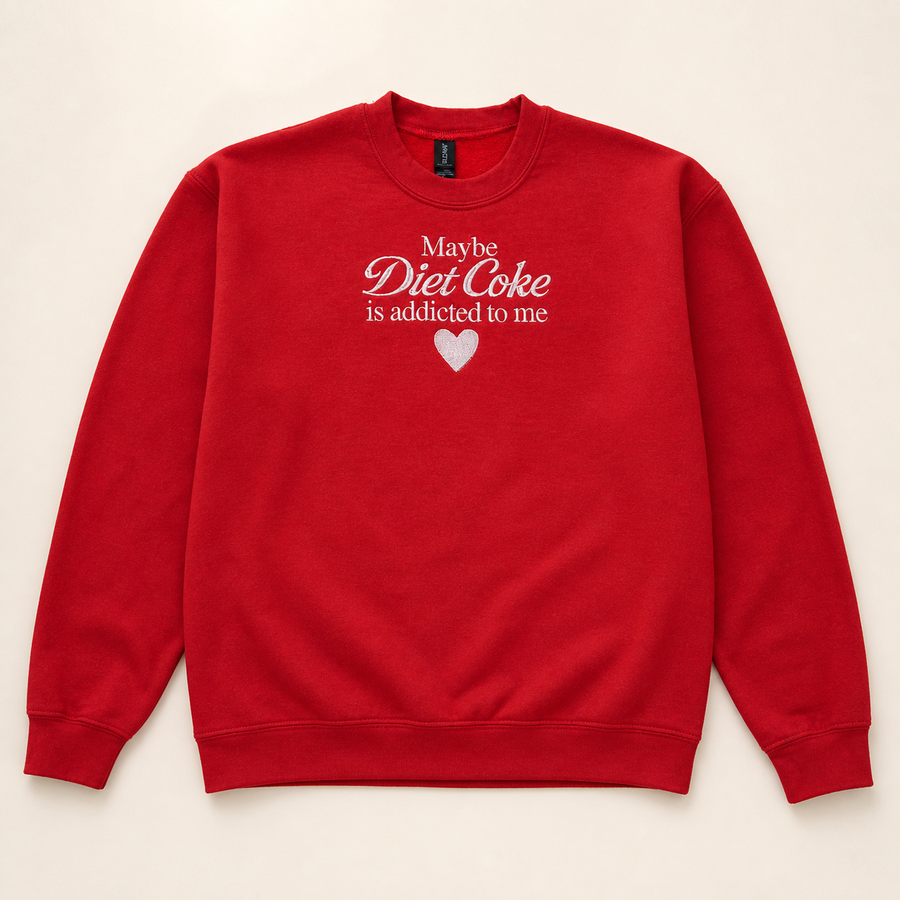 Red Diet Coke date embroidered sweatshirt on a warm ivory studio background