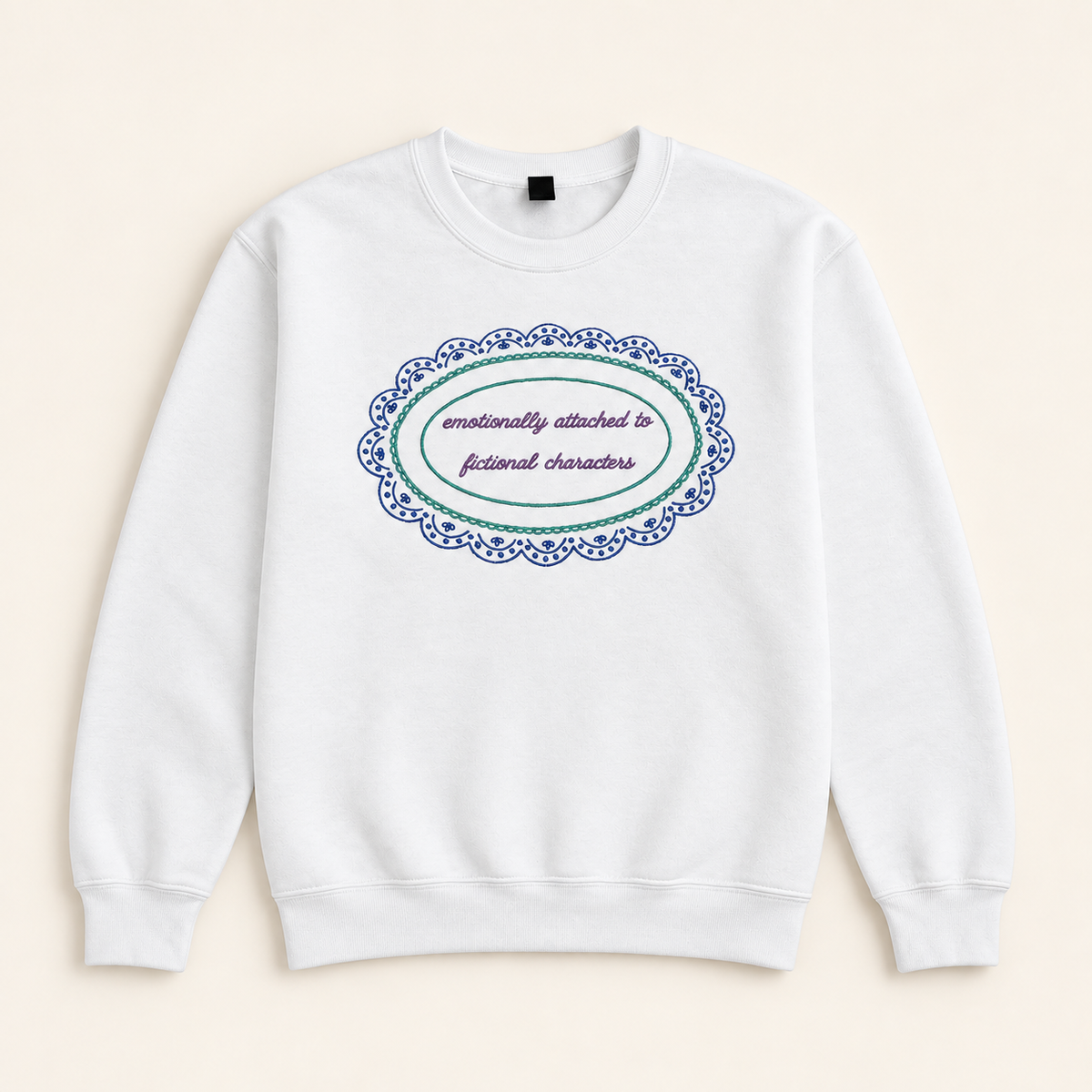 White Emotionally Attached to Fictional Characters embroidered sweatshirt, neatly arranged on a warm ivory studio background