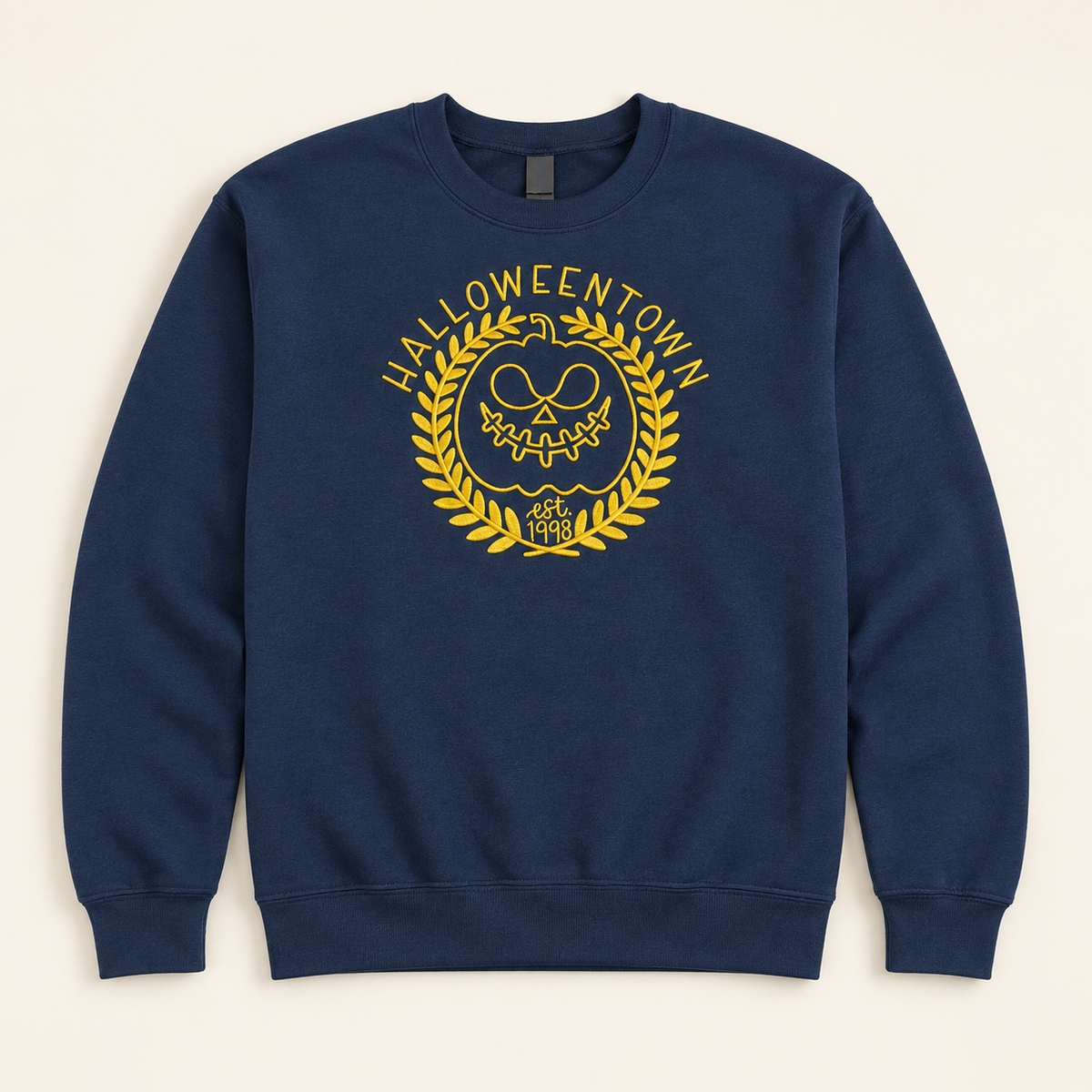 Navy Halloweentown embroidered sweatshirt, neatly arranged on a warm ivory studio background