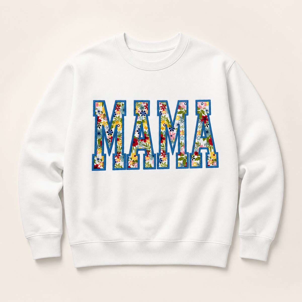 White personalized MAMA appliqué sweatshirt on a warm ivory studio background