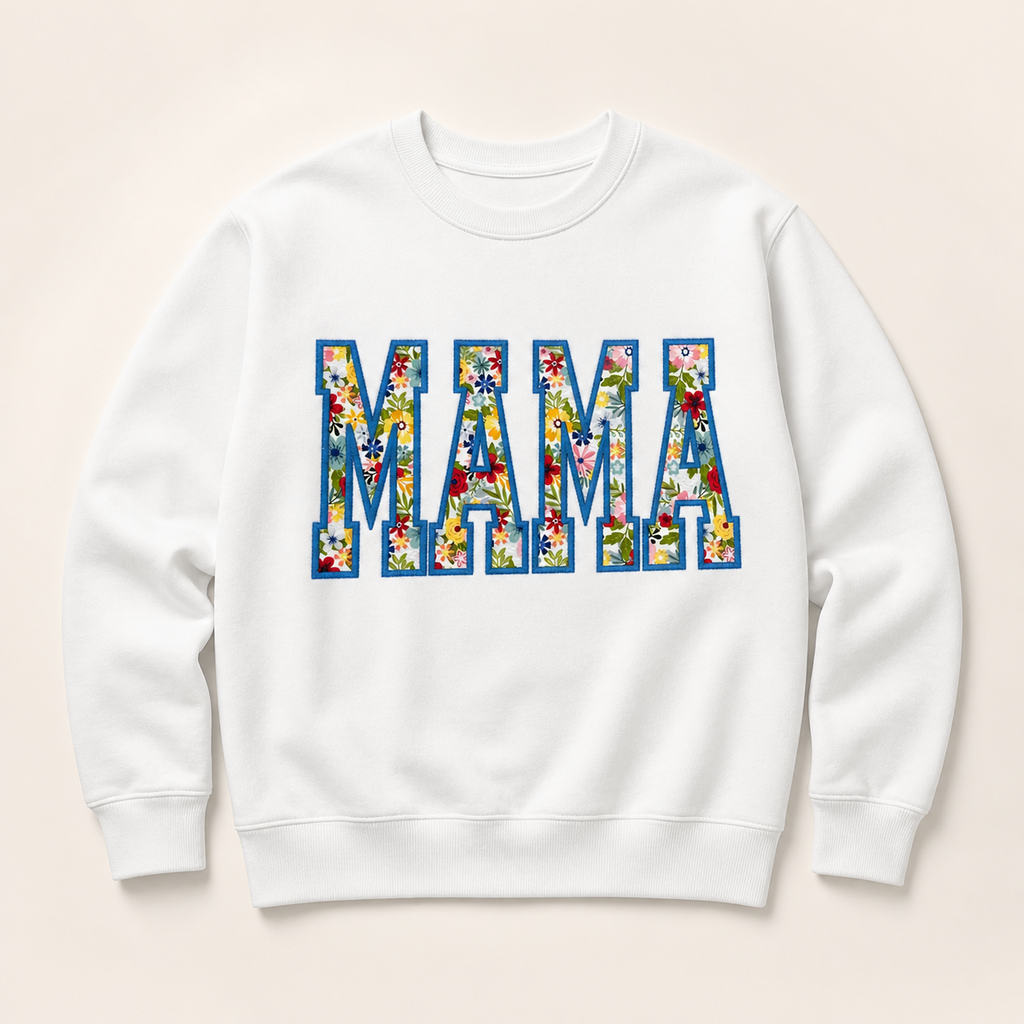 White personalized MAMA appliqué sweatshirt on a warm ivory studio background
