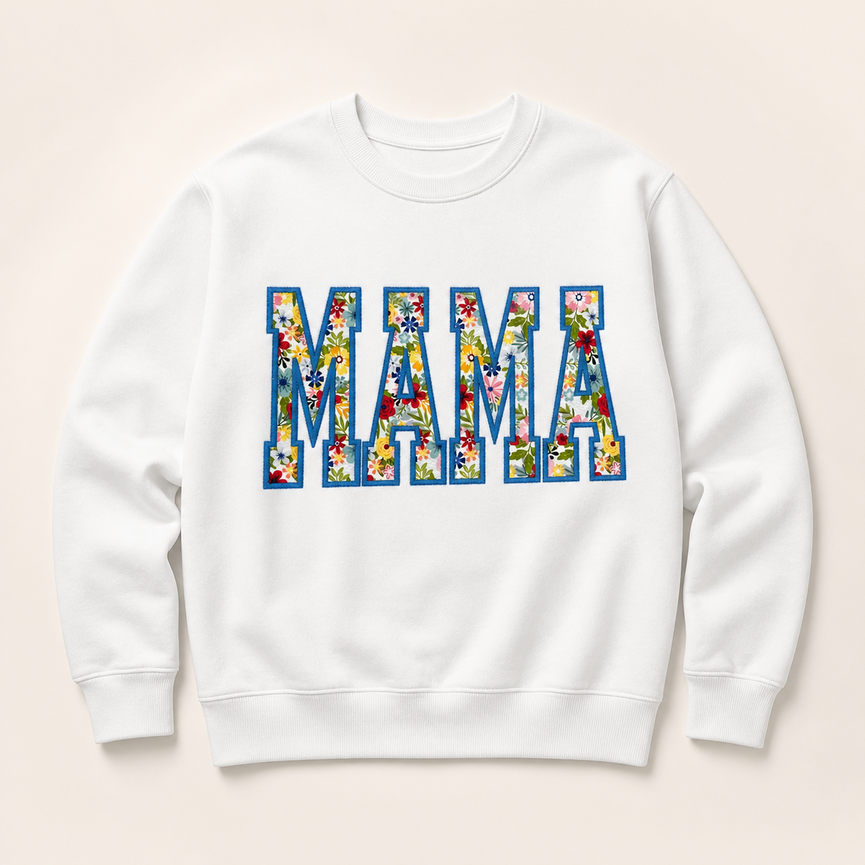 White personalized MAMA appliqué sweatshirt on a warm ivory studio background