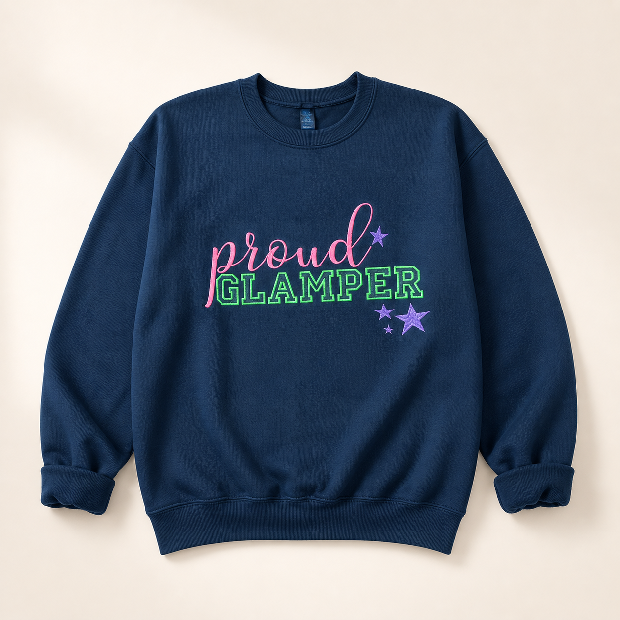 Navy Proud Glamper embroidered sweatshirt on a warm ivory studio background