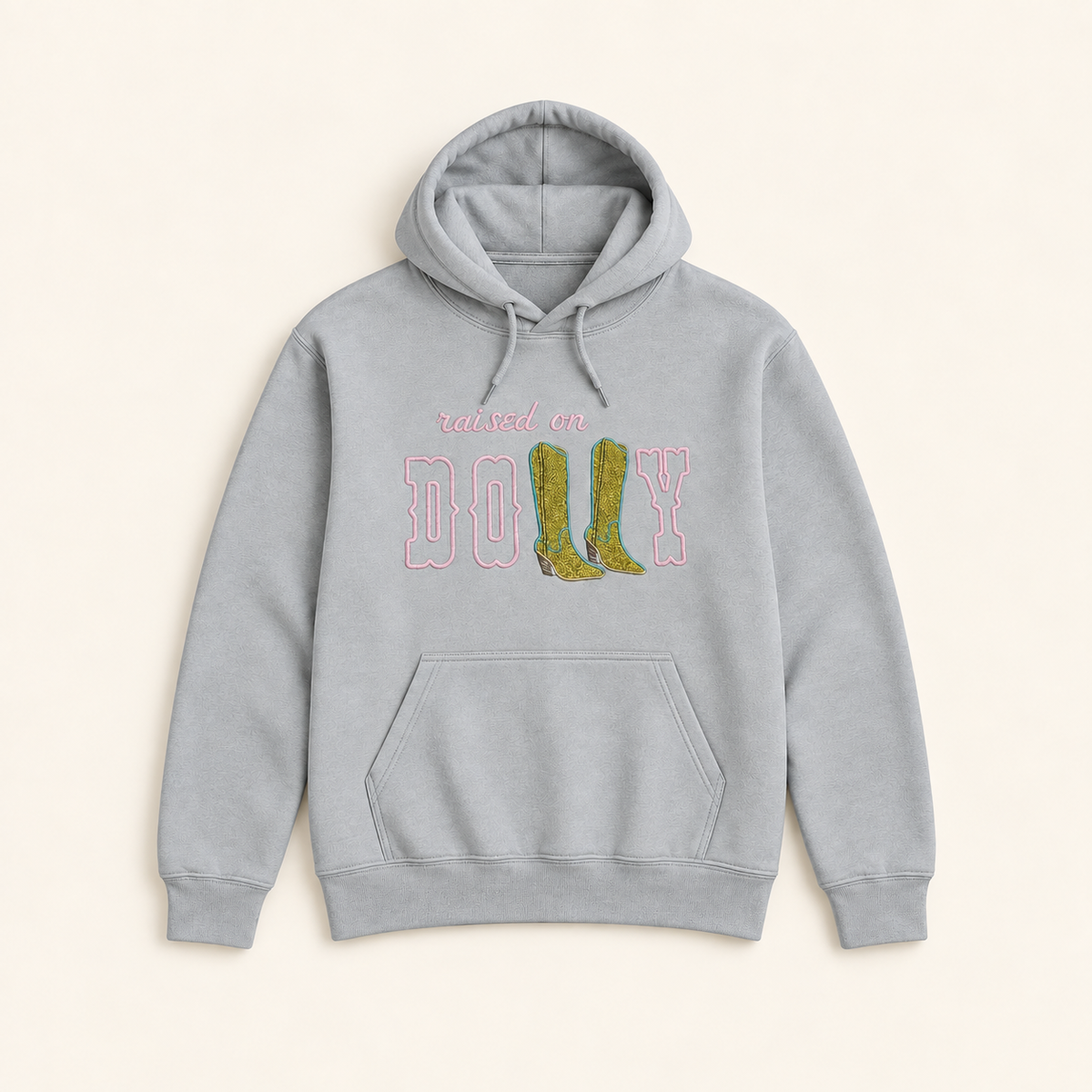 Light gray Raised on Dolly embroidered and glitter hoodie, neatly arranged on a warm ivory studio background