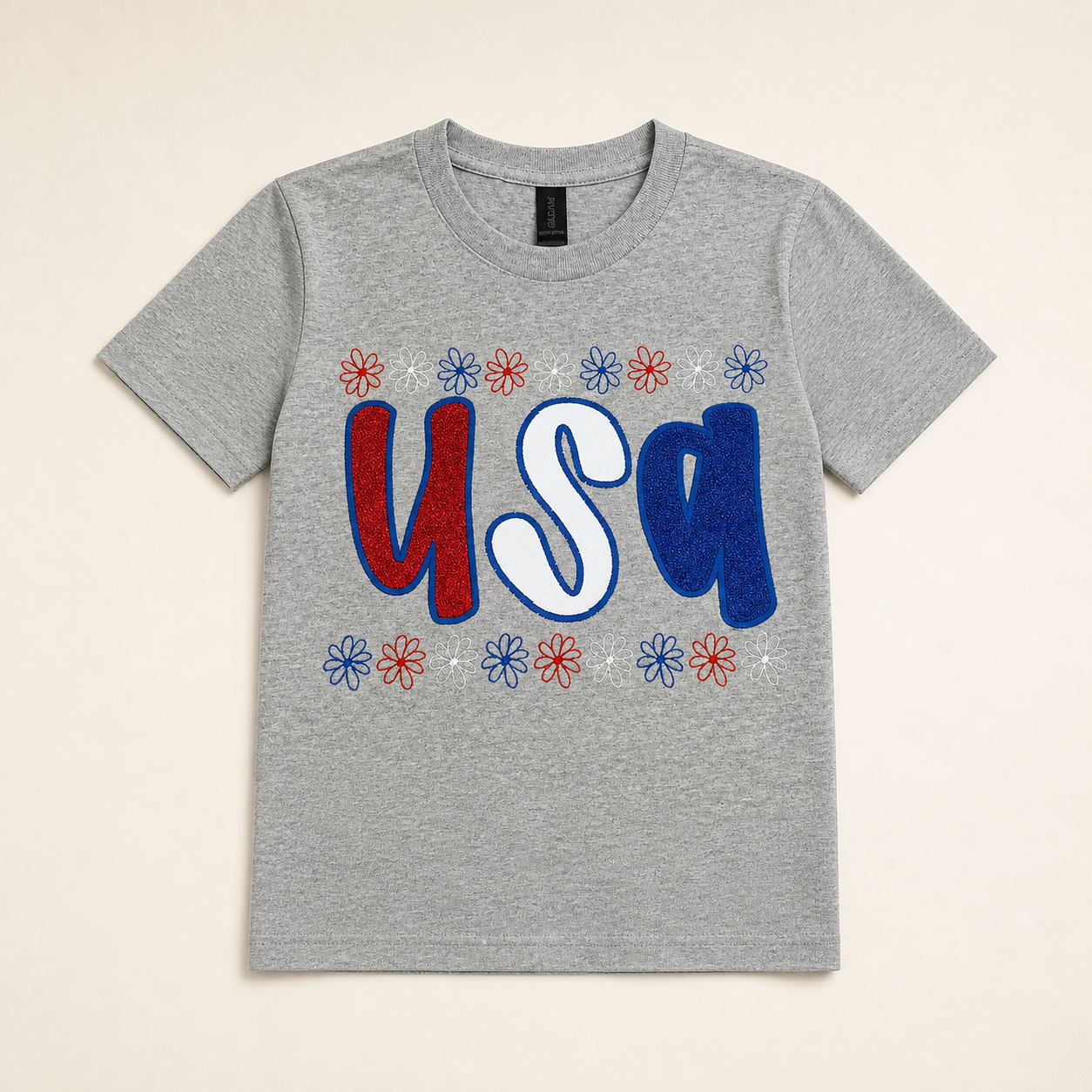 Heather-gray USA floral embroidered T-shirt on a warm ivory studio background
