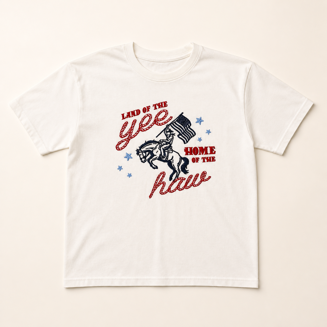 White Yeehaw embroidered T-shirt on a warm ivory studio background